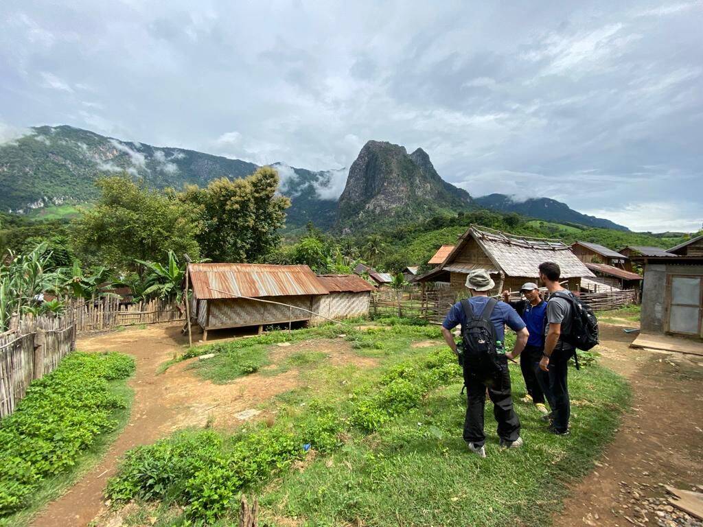 Khmu village houses under a limestone peak