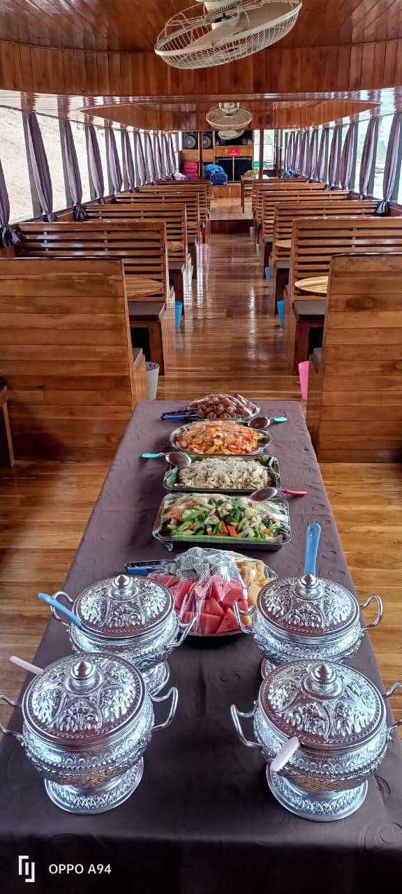 Lunch laid out in metal trays inside the wooden cabin